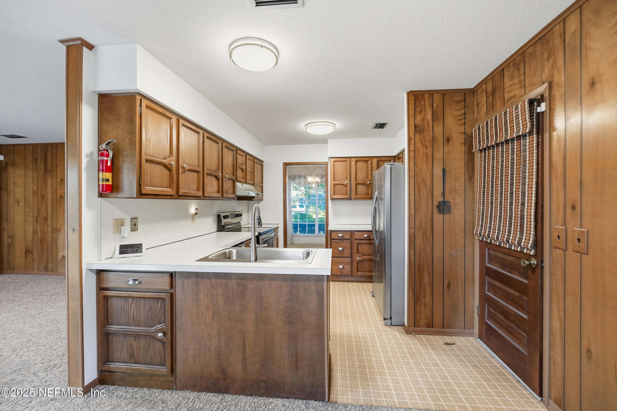 4073 Big Hollow Lane Jacksonville, FL 32277 - Photo 8 of 31 a kitchen with a sink refrigerator and cabinets