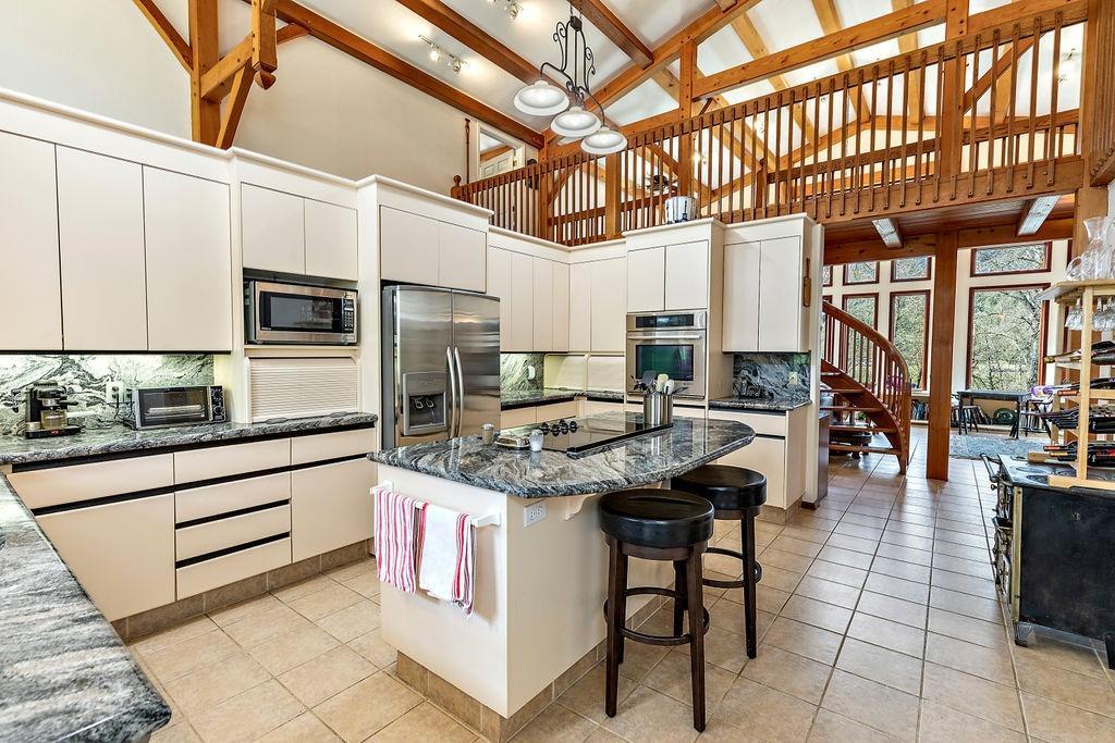 2076 Upper Applegate Road Jacksonville, OR 97530 - Photo 13 of 35 a kitchen with stainless steel appliances granite countertop a stove and cabinets