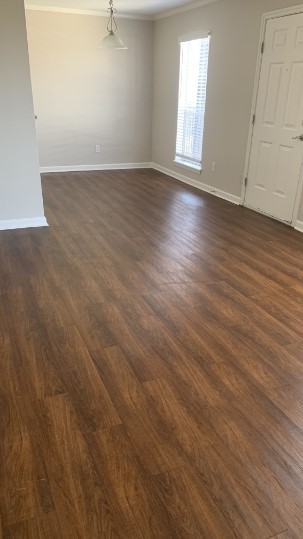 7315 Brompton Street, Unit 366B Houston, TX 77025 - Photo 4 of 11 an empty room with wooden floor and windows