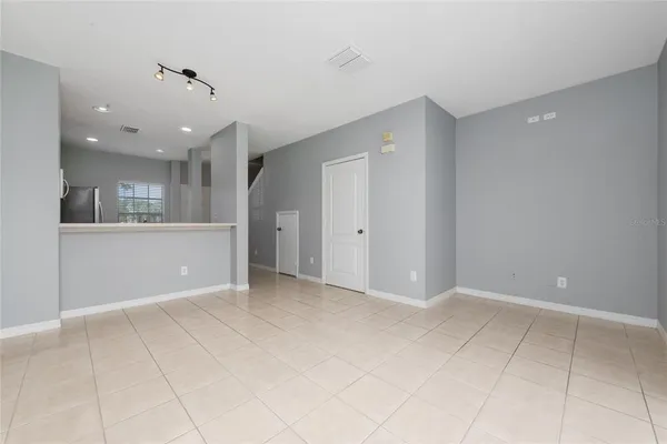 a view of an empty room with a kitchen