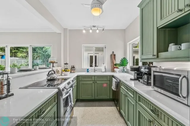 a kitchen with a sink stove top oven and cabinets