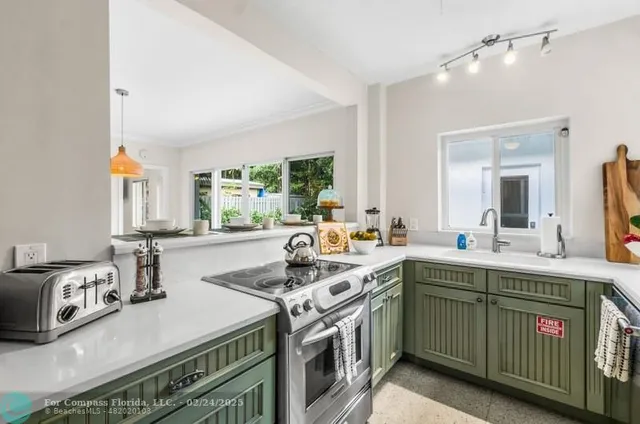 a kitchen that has a sink and a stove in it