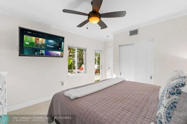 a bedroom with a bed and a flat screen tv
