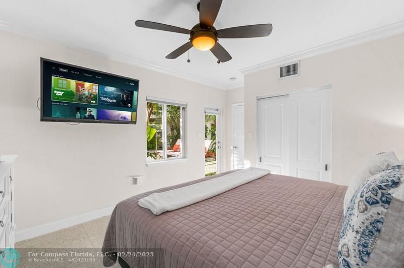 3310 Northeast 18th Street Fort Lauderdale, FL 33305 - Photo 19 of 39 a bedroom with a bed and a flat screen tv