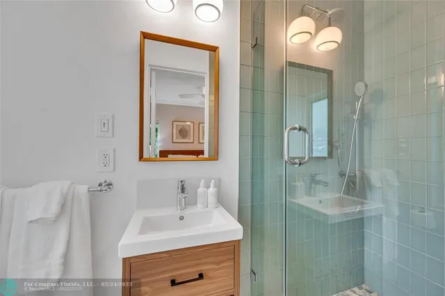 a bathroom with a sink vanity and a mirror