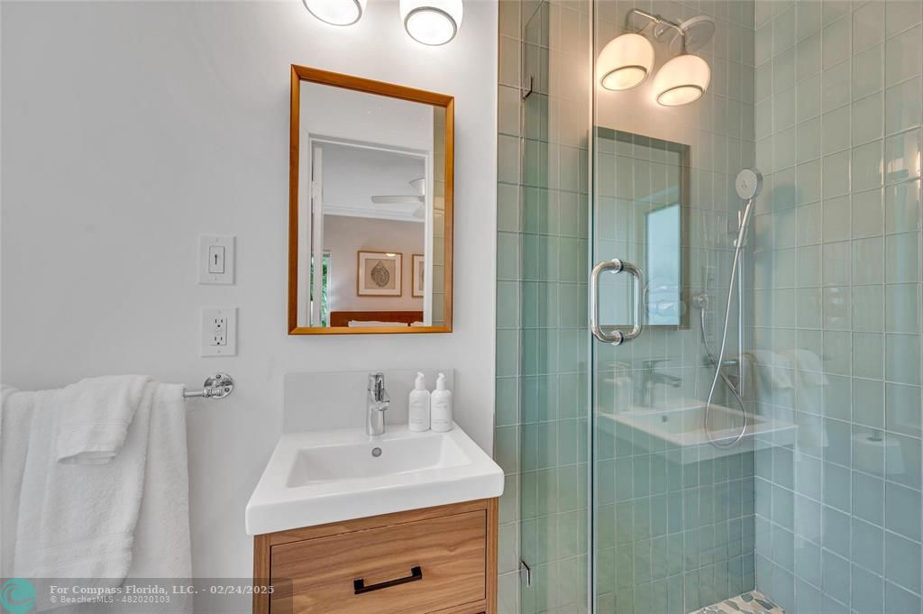 3310 Northeast 18th Street Fort Lauderdale, FL 33305 - Photo 23 of 39 a bathroom with a sink vanity and a mirror