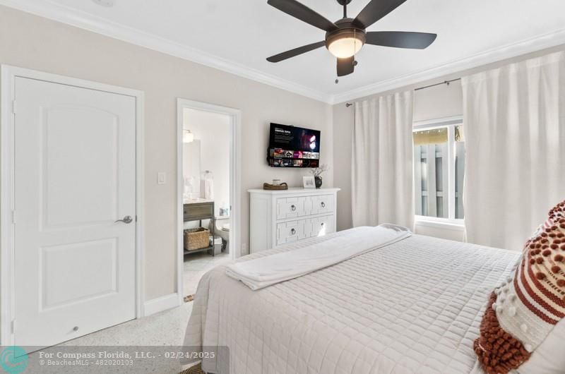 3310 Northeast 18th Street Fort Lauderdale, FL 33305 - Photo 25 of 39 a bedroom with a bed and a flat screen tv