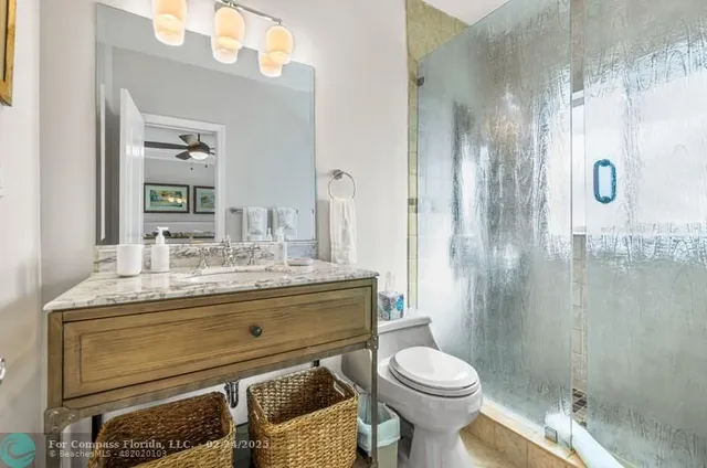 a bathroom with a sink toilet and shower