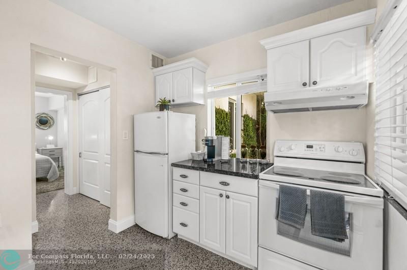 3310 Northeast 18th Street Fort Lauderdale, FL 33305 - Photo 30 of 39 a kitchen with white cabinets and white appliances