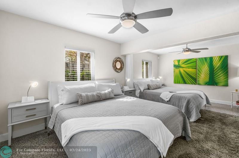 3310 Northeast 18th Street Fort Lauderdale, FL 33305 - Photo 31 of 39 a bedroom with a bed and a chandelier