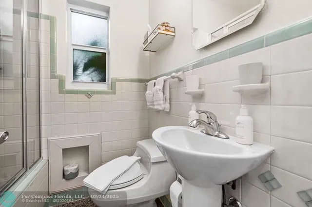 a bathroom with a sink a toilet and mirror