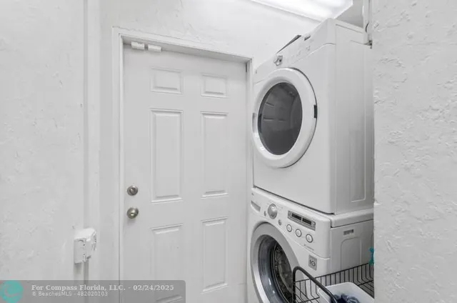 a view of a storage and utility room with washer and dryer