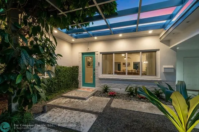 a view of a porch with a table and chairs