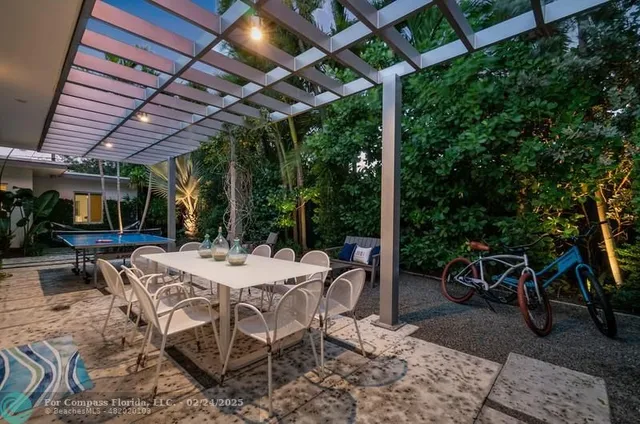 a view of a patio with a table and chairs under a umbrella