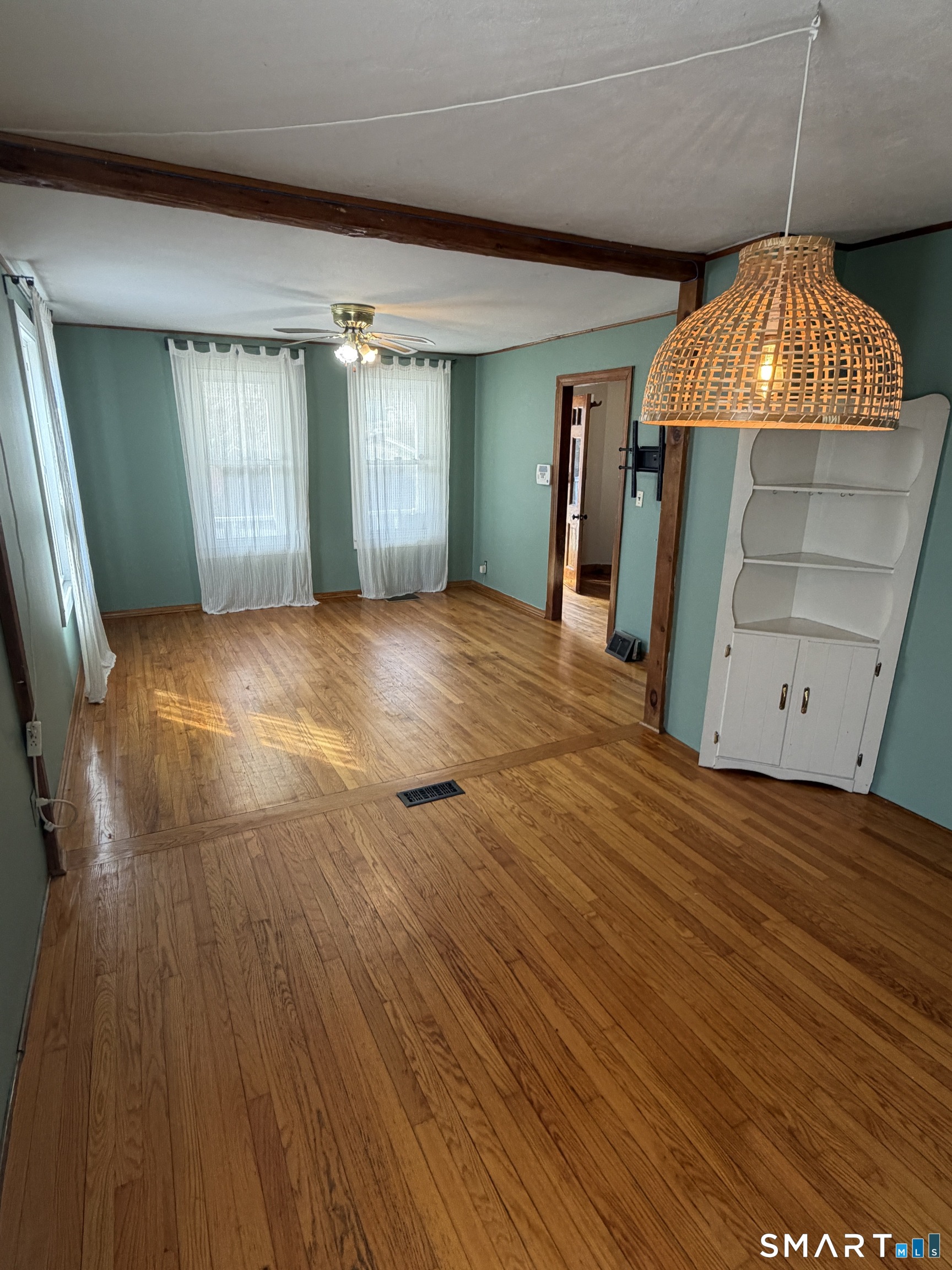 70 Meadow Street Ansonia, CT 06401 - Photo 2 of 12 an empty room with wooden floor and cabinet