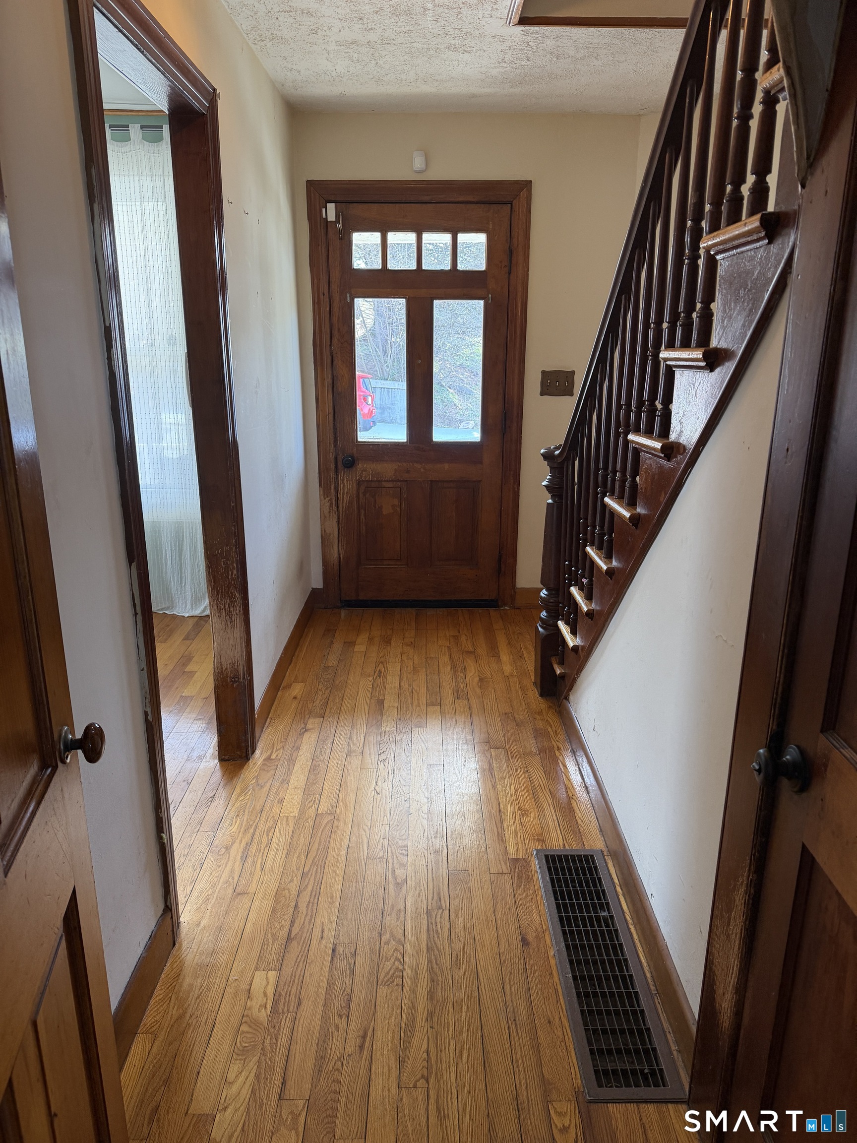 70 Meadow Street Ansonia, CT 06401 - Photo 5 of 12 a view of an entryway with wooden floor and stairs