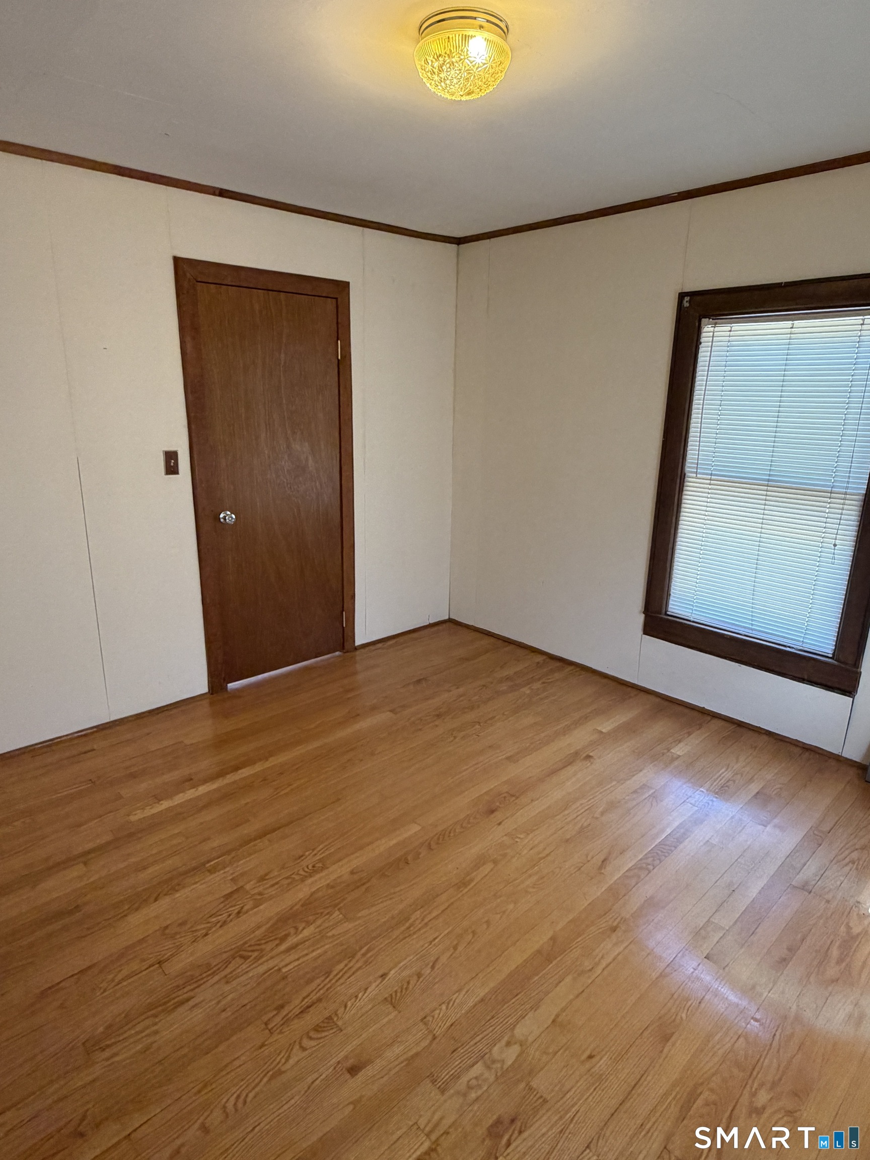 70 Meadow Street Ansonia, CT 06401 - Photo 9 of 12 an empty room with wooden floor and closet