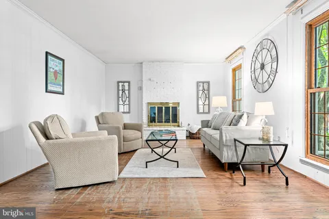 a living room with furniture a table and a large window