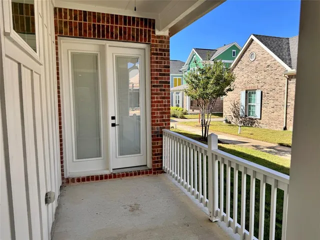 a view of a house with a small yard and wooden fence