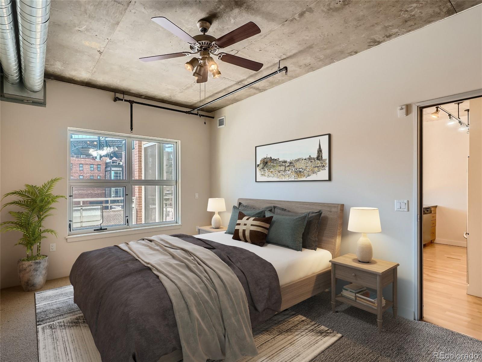 2229 Blake Street, Unit 406 Denver, CO 80205 - Photo 14 of 27 a bedroom with a large bed and a window