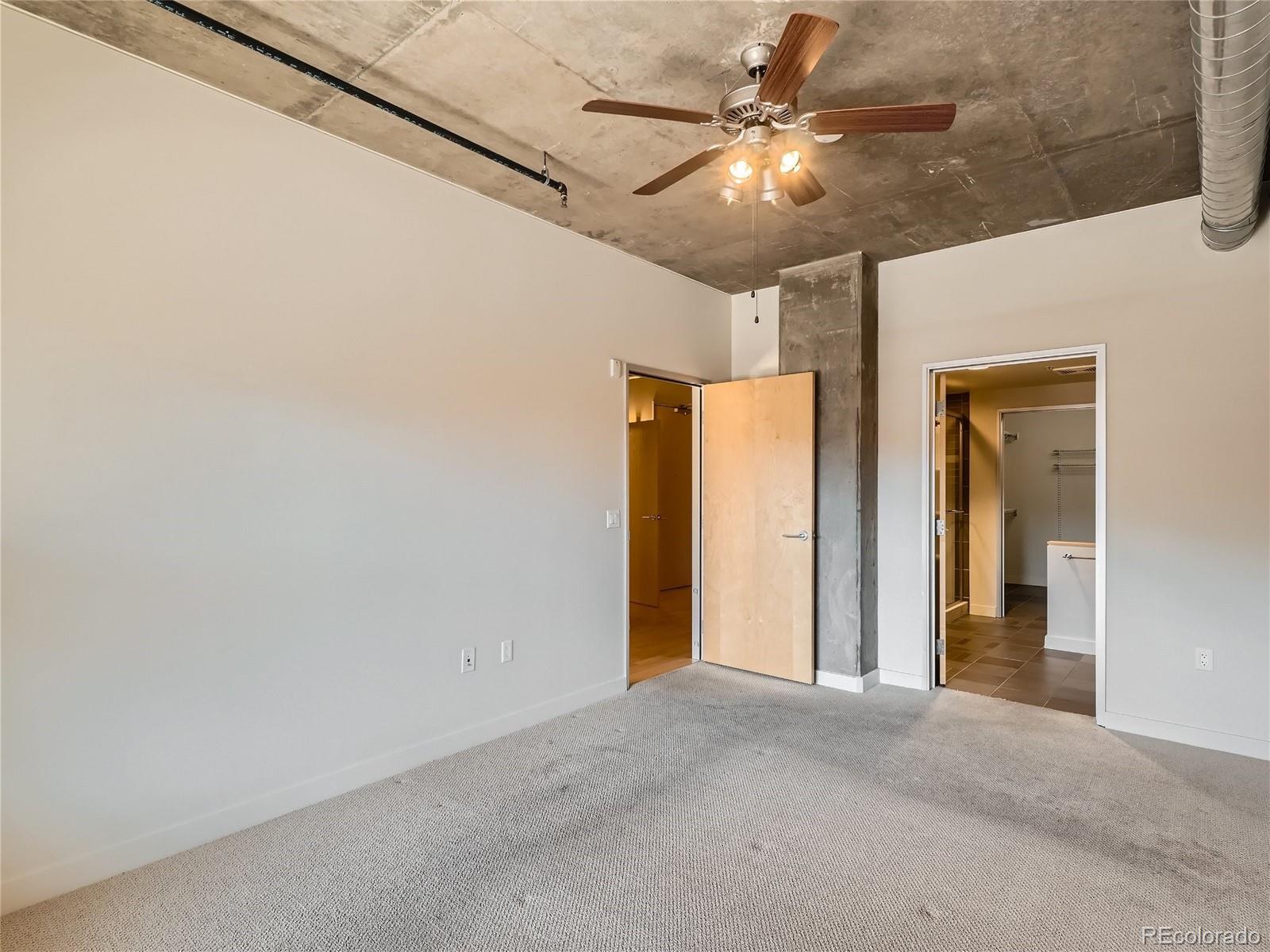 2229 Blake Street, Unit 406 Denver, CO 80205 - Photo 15 of 27 a view of a hallway with a chandelier fan