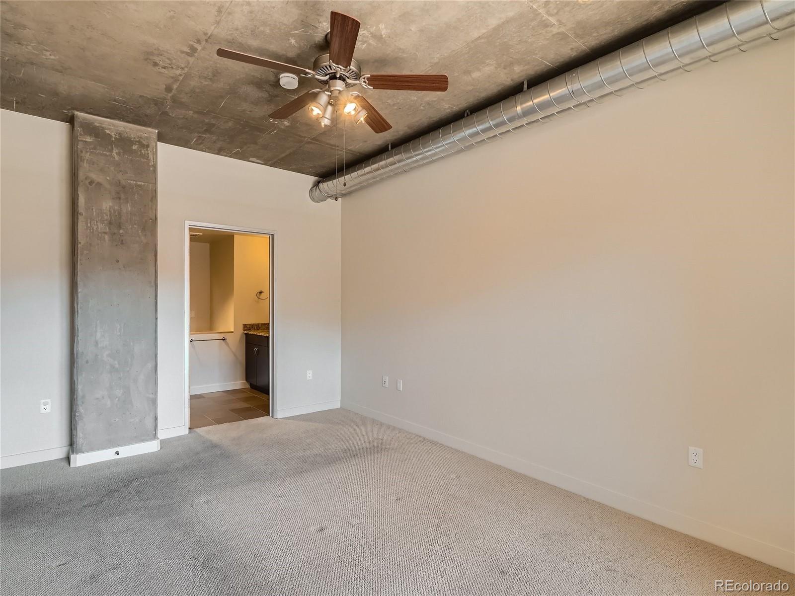 2229 Blake Street, Unit 406 Denver, CO 80205 - Photo 16 of 27 a view of a hallway with a chandelier fan