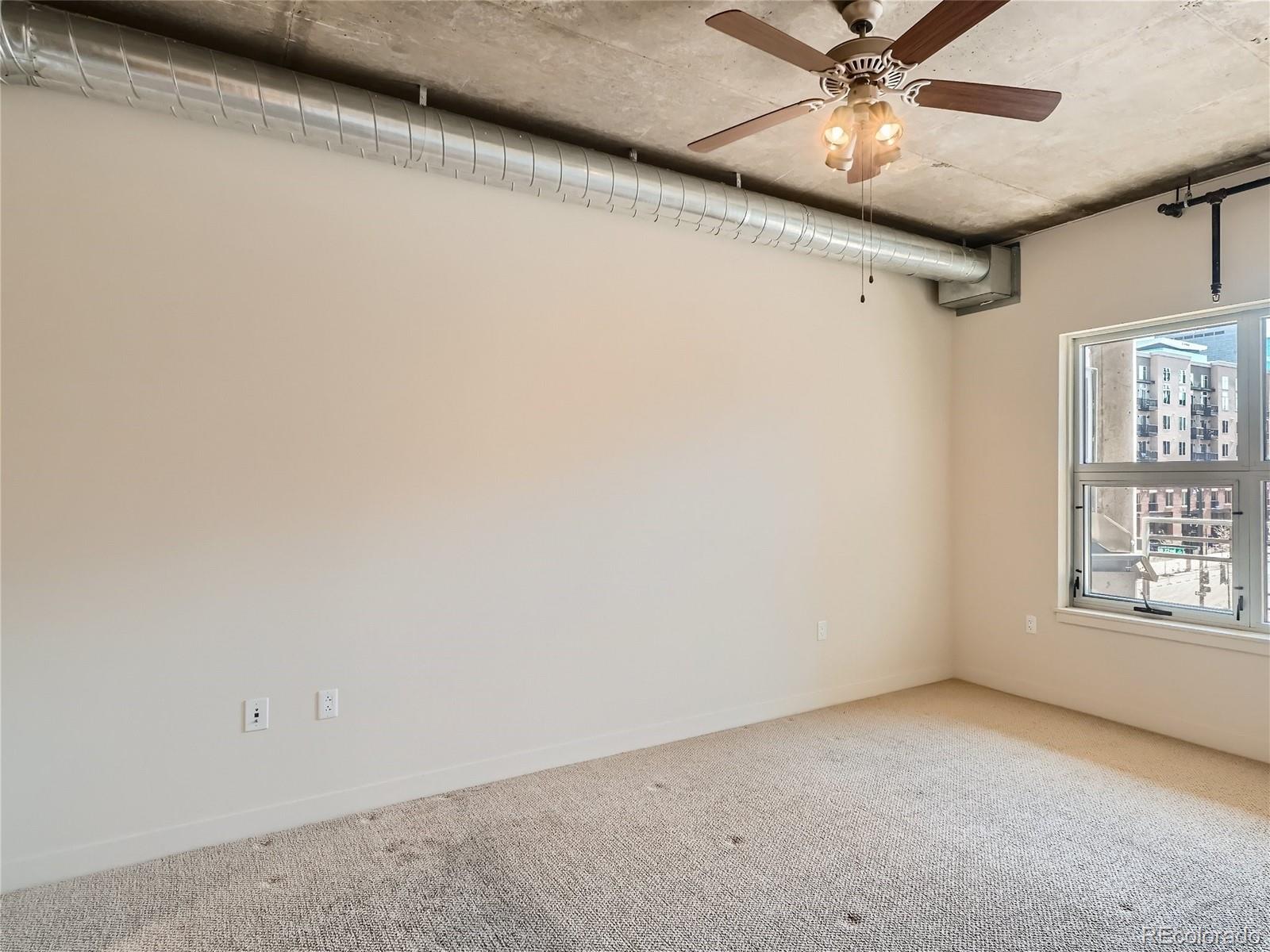2229 Blake Street, Unit 406 Denver, CO 80205 - Photo 17 of 27 a view of an empty room with a window
