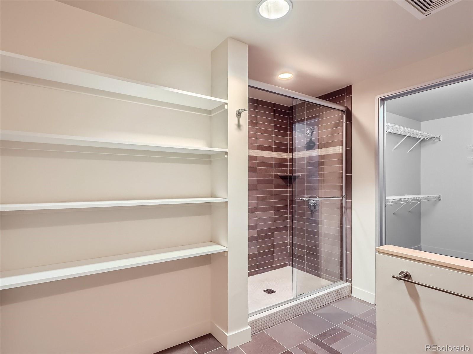 2229 Blake Street, Unit 406 Denver, CO 80205 - Photo 18 of 27 a bathroom with a shower and a sink