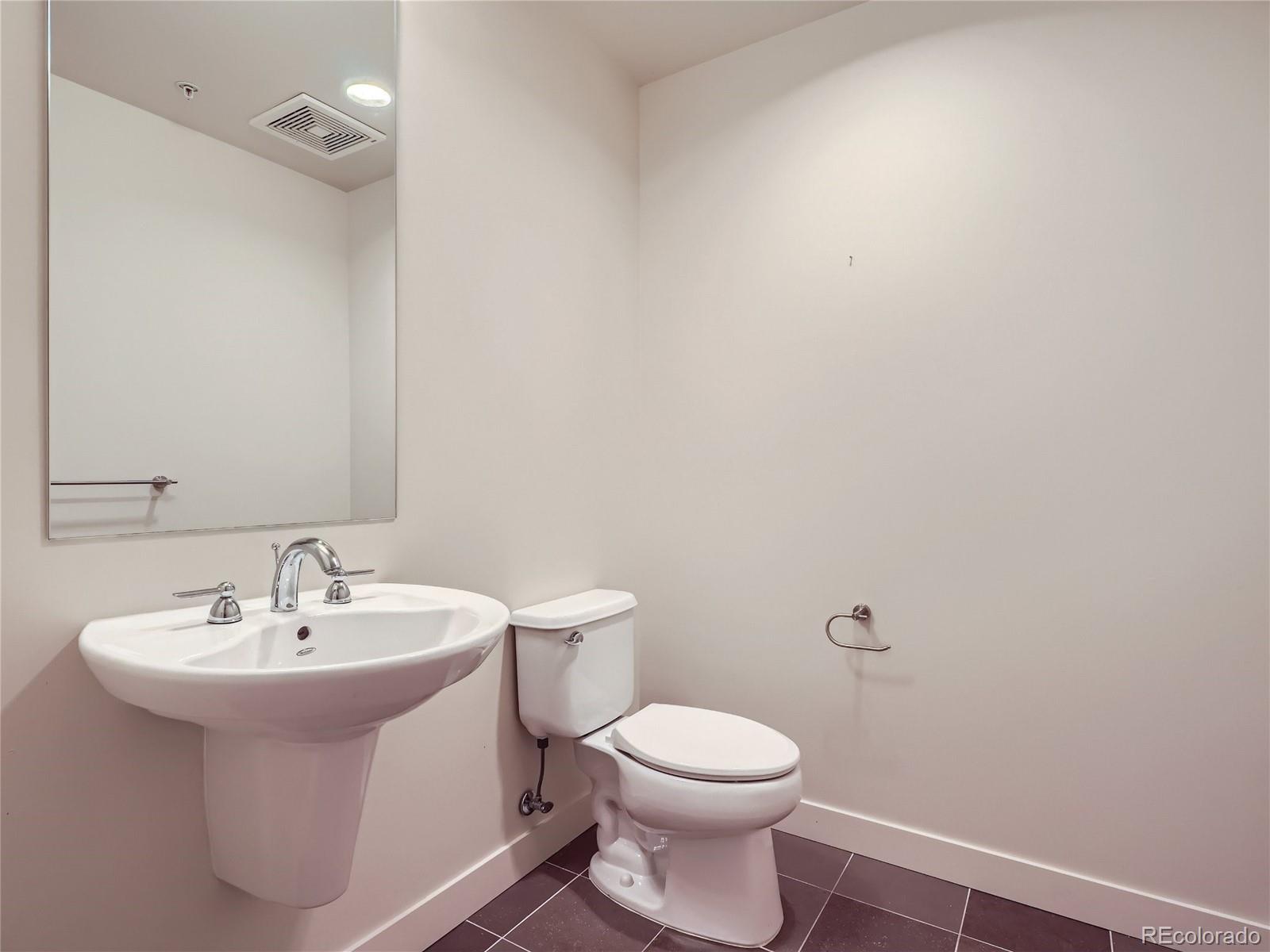 2229 Blake Street, Unit 406 Denver, CO 80205 - Photo 22 of 27 a bathroom with a sink and a toilet