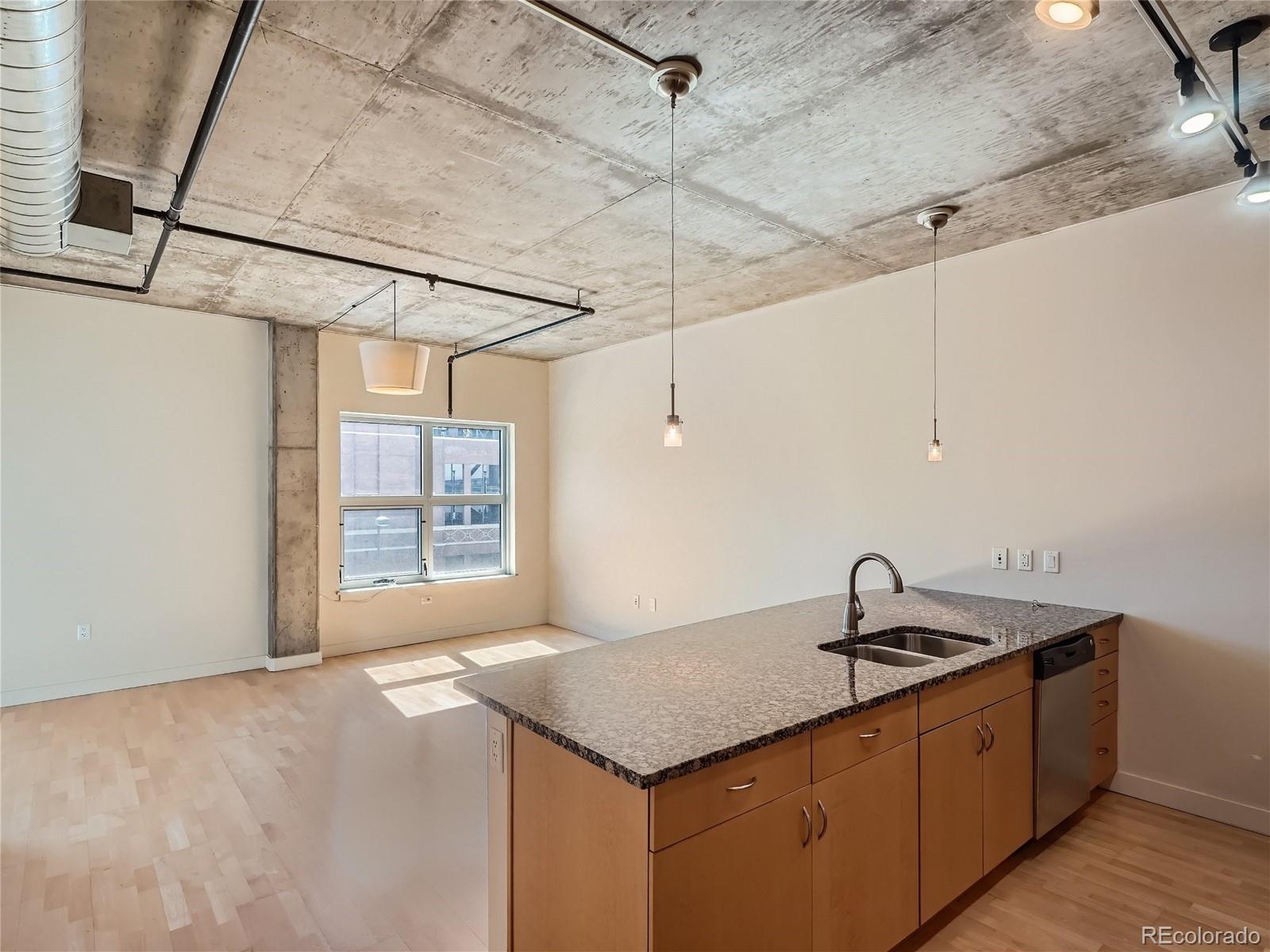 2229 Blake Street, Unit 406 Denver, CO 80205 - Photo 7 of 27 a kitchen with a sink cabinets and window