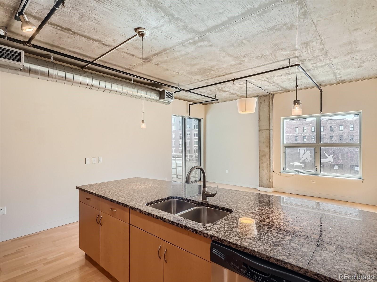 2229 Blake Street, Unit 406 Denver, CO 80205 - Photo 8 of 27 a kitchen with a sink and large window