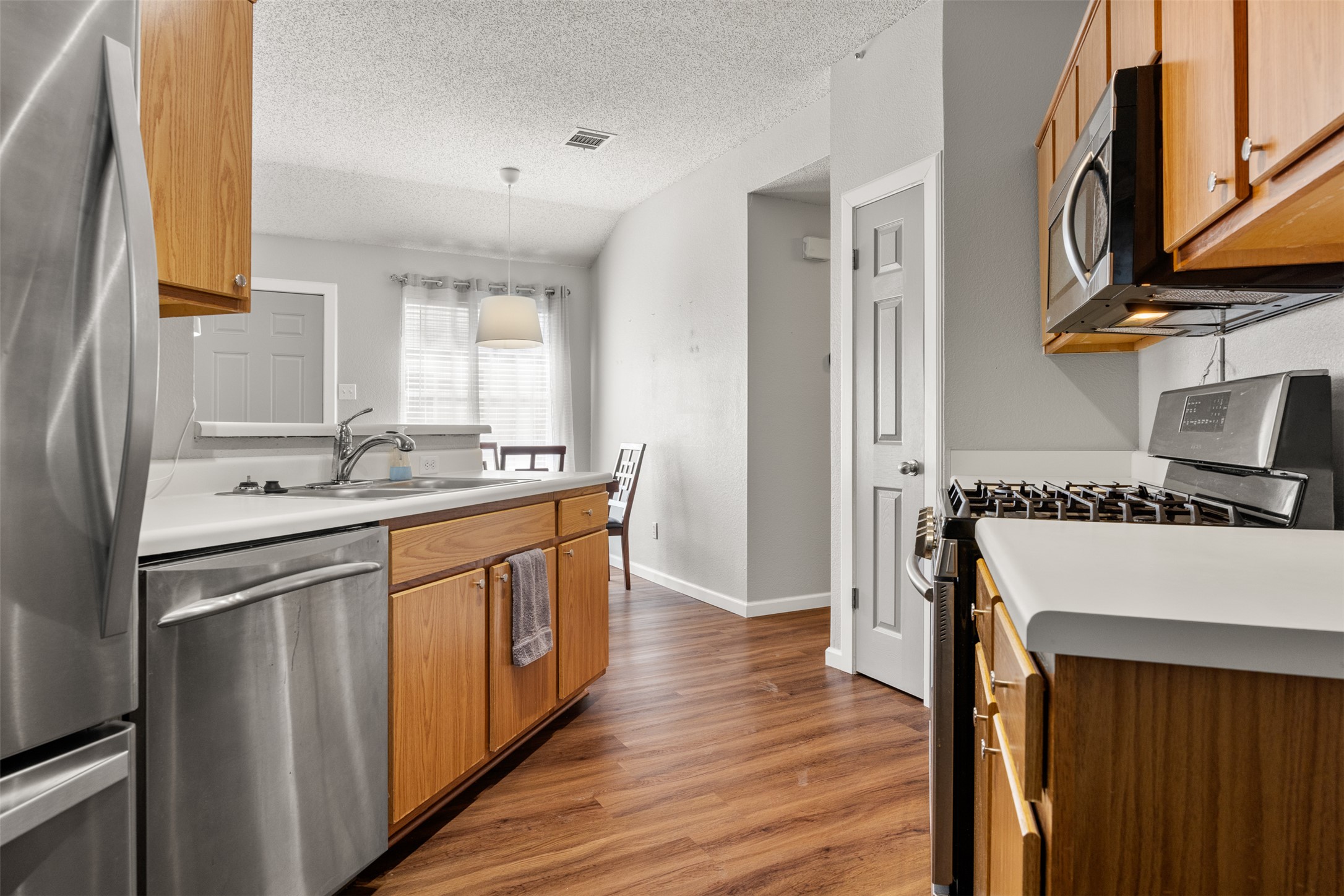 8120 Tockington Way Austin, TX 78748 - Photo 12 of 27 a kitchen with stainless steel appliances granite countertop a sink stove and refrigerator