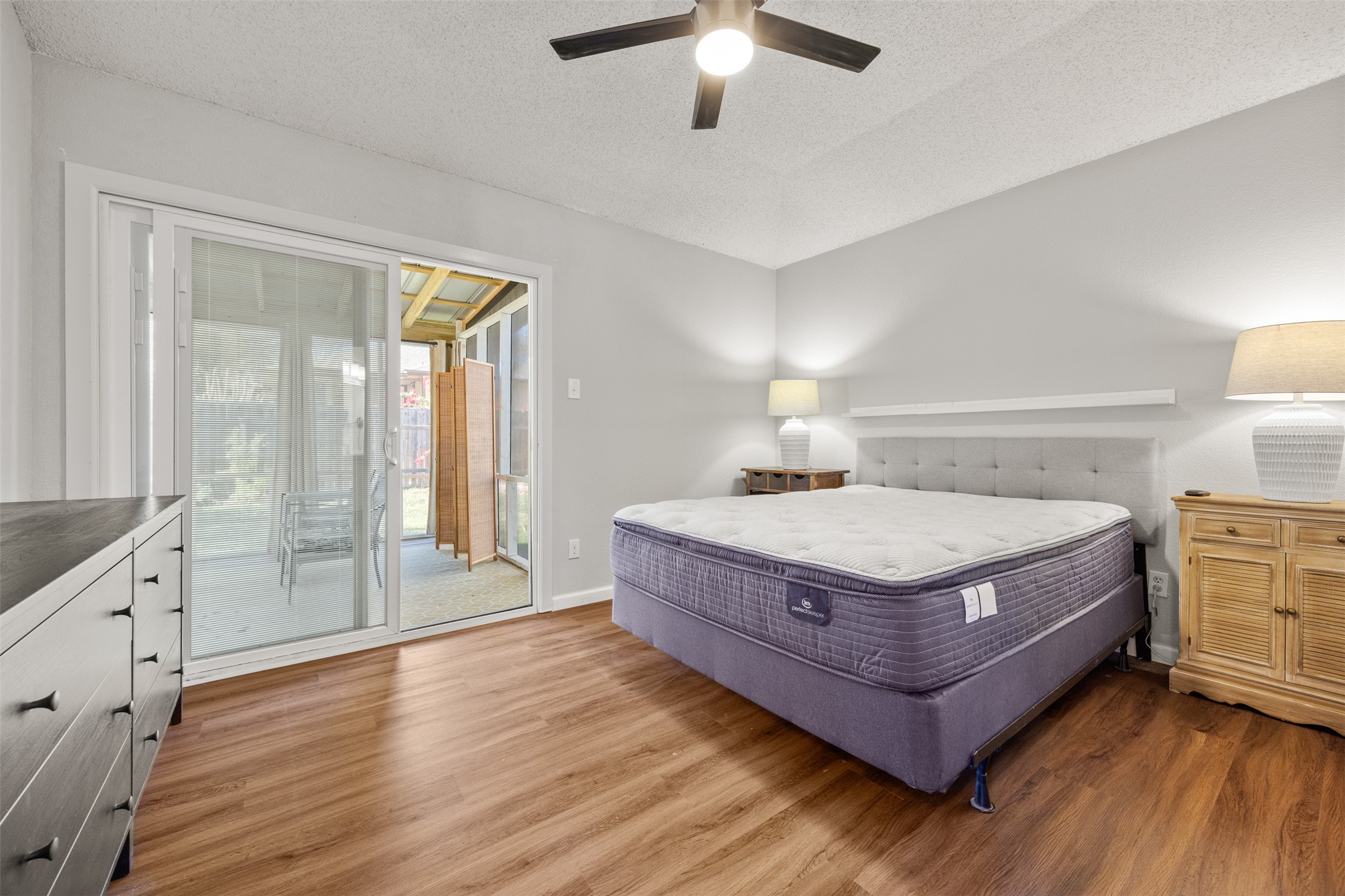 8120 Tockington Way Austin, TX 78748 - Photo 16 of 27 a living room with hard wood floors and a ceiling fan