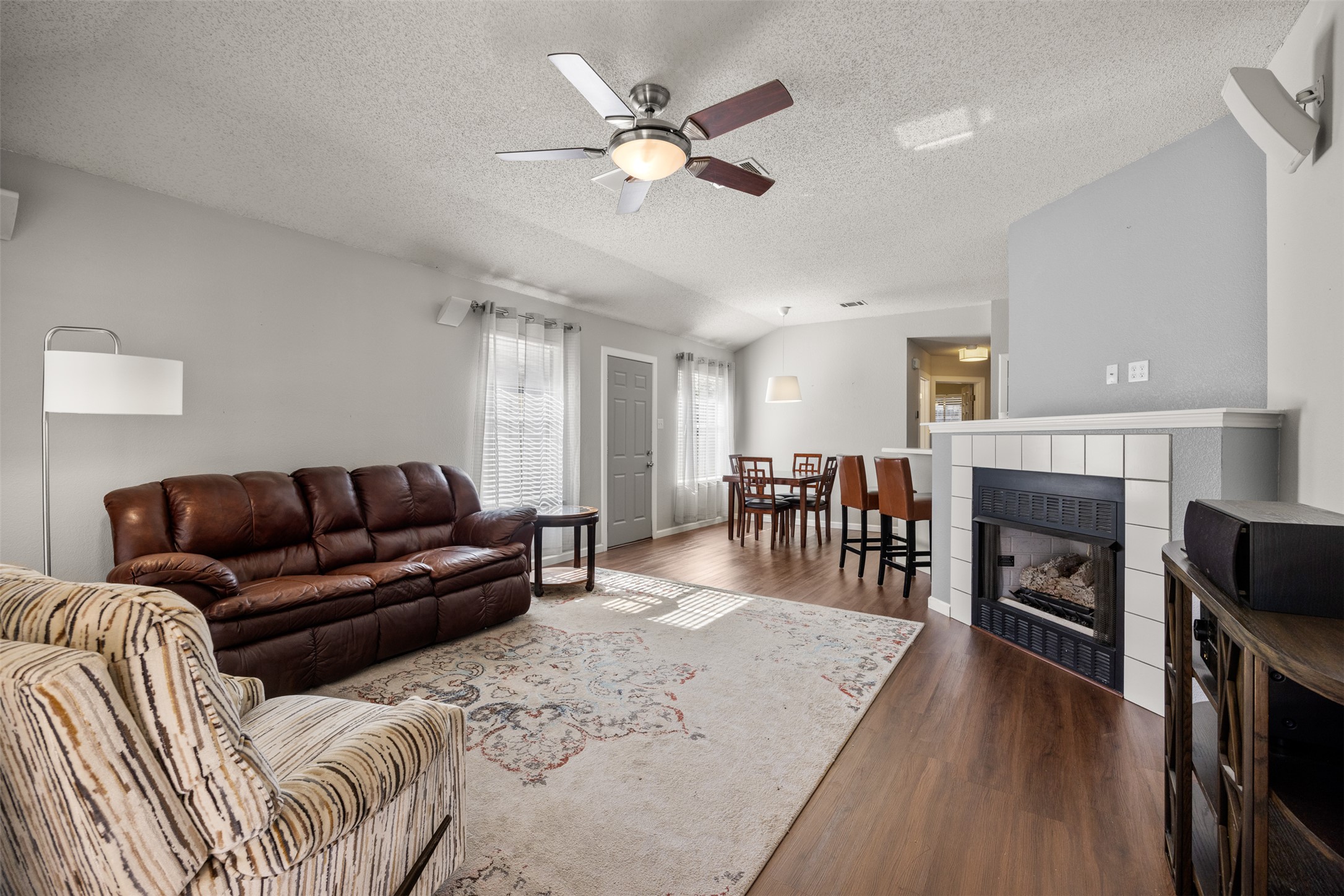 8120 Tockington Way Austin, TX 78748 - Photo 6 of 27 a living room with furniture and a fireplace