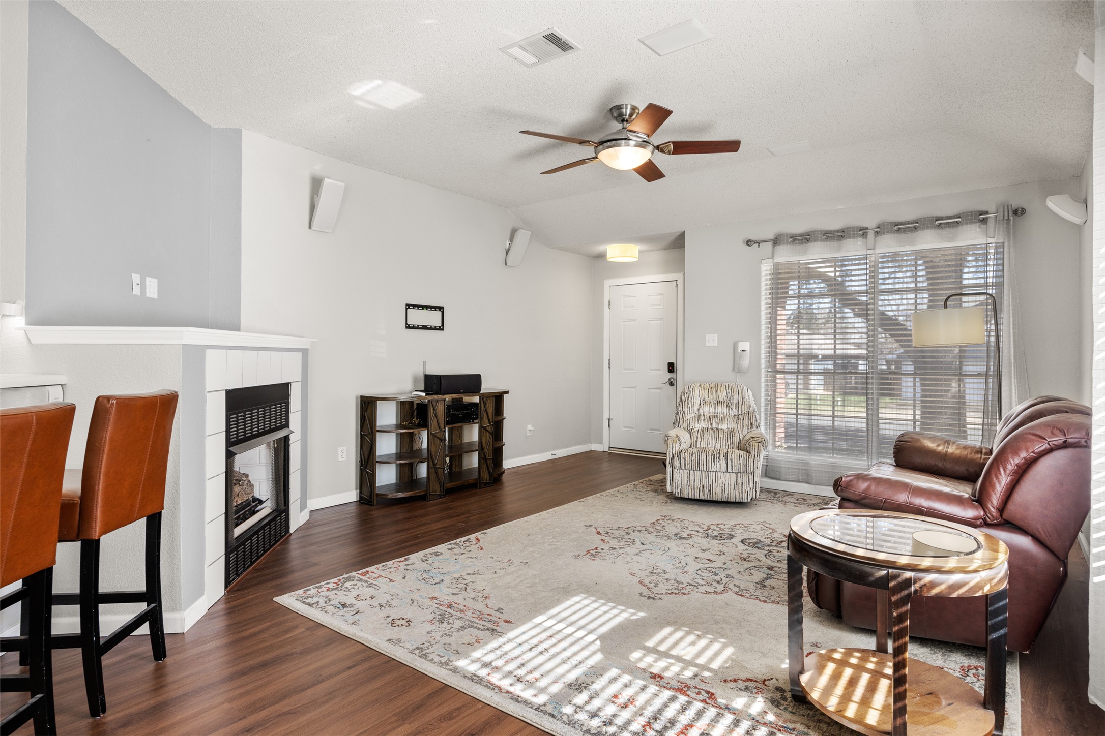 8120 Tockington Way Austin, TX 78748 - Photo 7 of 27 a living room with furniture and a fireplace