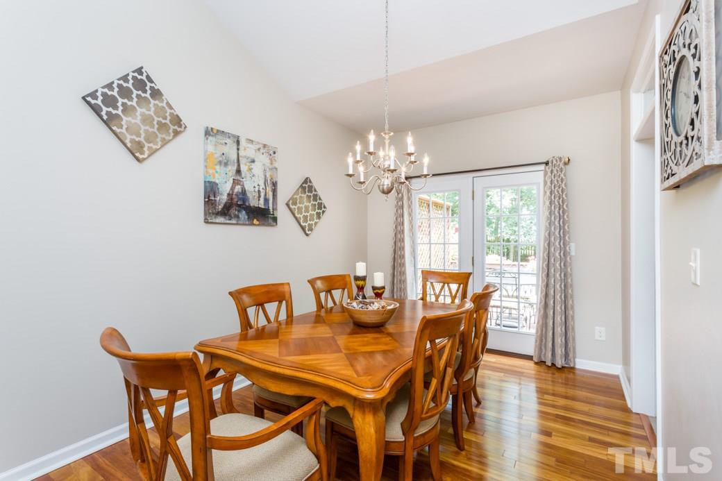5206 Groveside Court Raleigh, NC 27613 - Photo 3 of 12 a dining room with furniture and chandelier