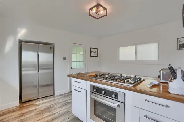 a kitchen with stainless steel appliances granite countertop a stove and a refrigerator