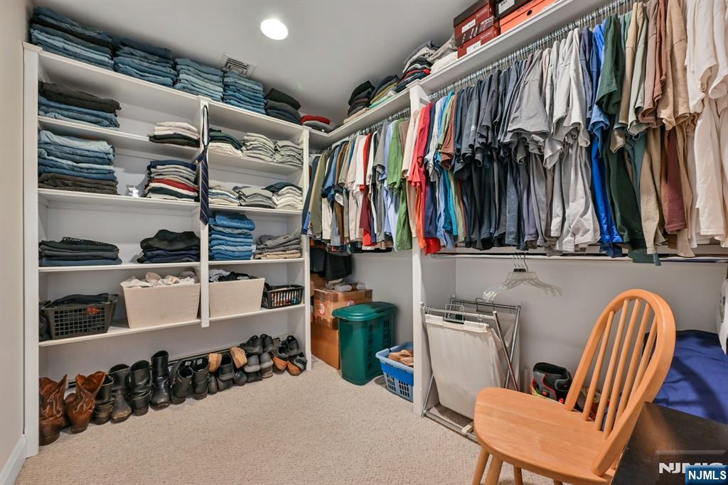 285 Chestnut Ridge Road Woodcliff Lake, NJ 07677 - Photo 40 of 46 a view of walk in closet with clothes and shoes