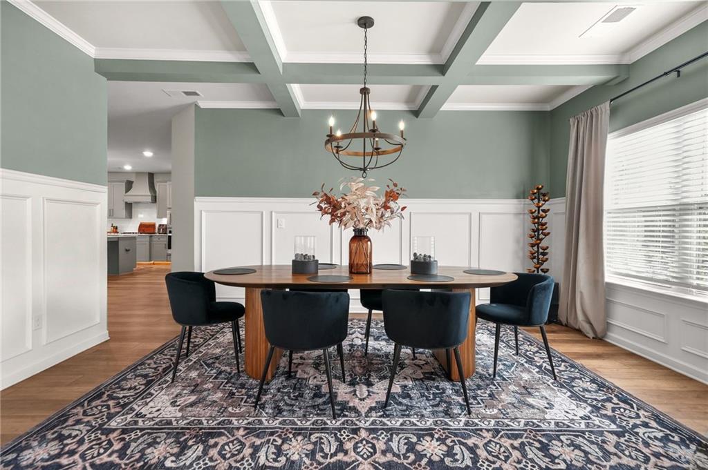 118 Arabella Pike Locust Grove, GA 30248 - Photo 19 of 39 a view of a dining room with furniture a chandelier and wooden floor