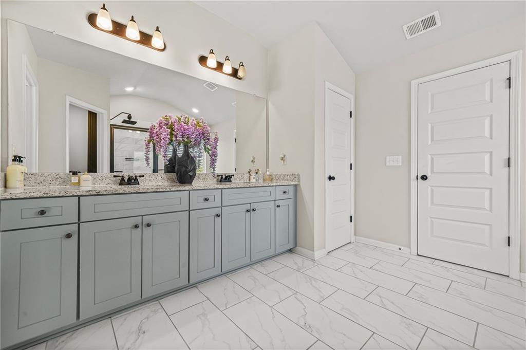 118 Arabella Pike Locust Grove, GA 30248 - Photo 24 of 39 a spacious bathroom with a granite countertop sink mirror and a