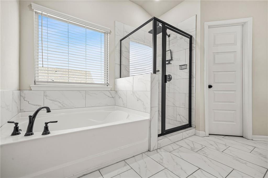 118 Arabella Pike Locust Grove, GA 30248 - Photo 25 of 39 a bathroom with a bathtub and a shower