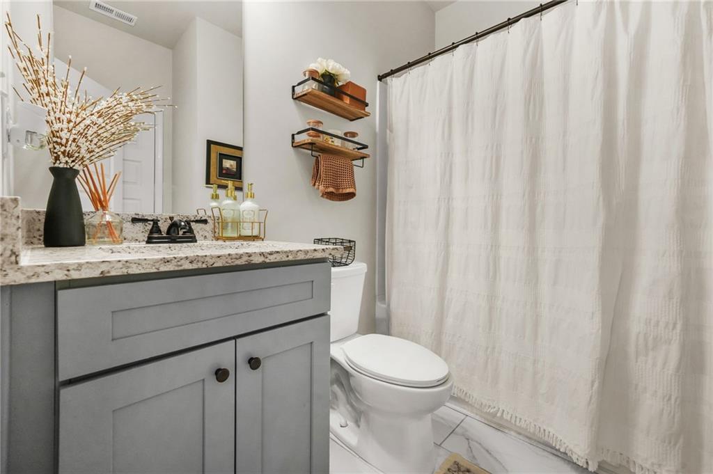 118 Arabella Pike Locust Grove, GA 30248 - Photo 30 of 39 a bathroom with a granite countertop sink and a mirror