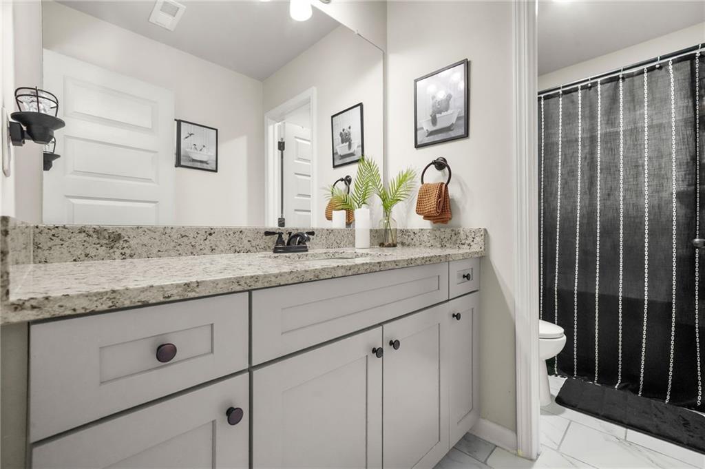 118 Arabella Pike Locust Grove, GA 30248 - Photo 32 of 39 a bathroom with a granite countertop sink and a mirror