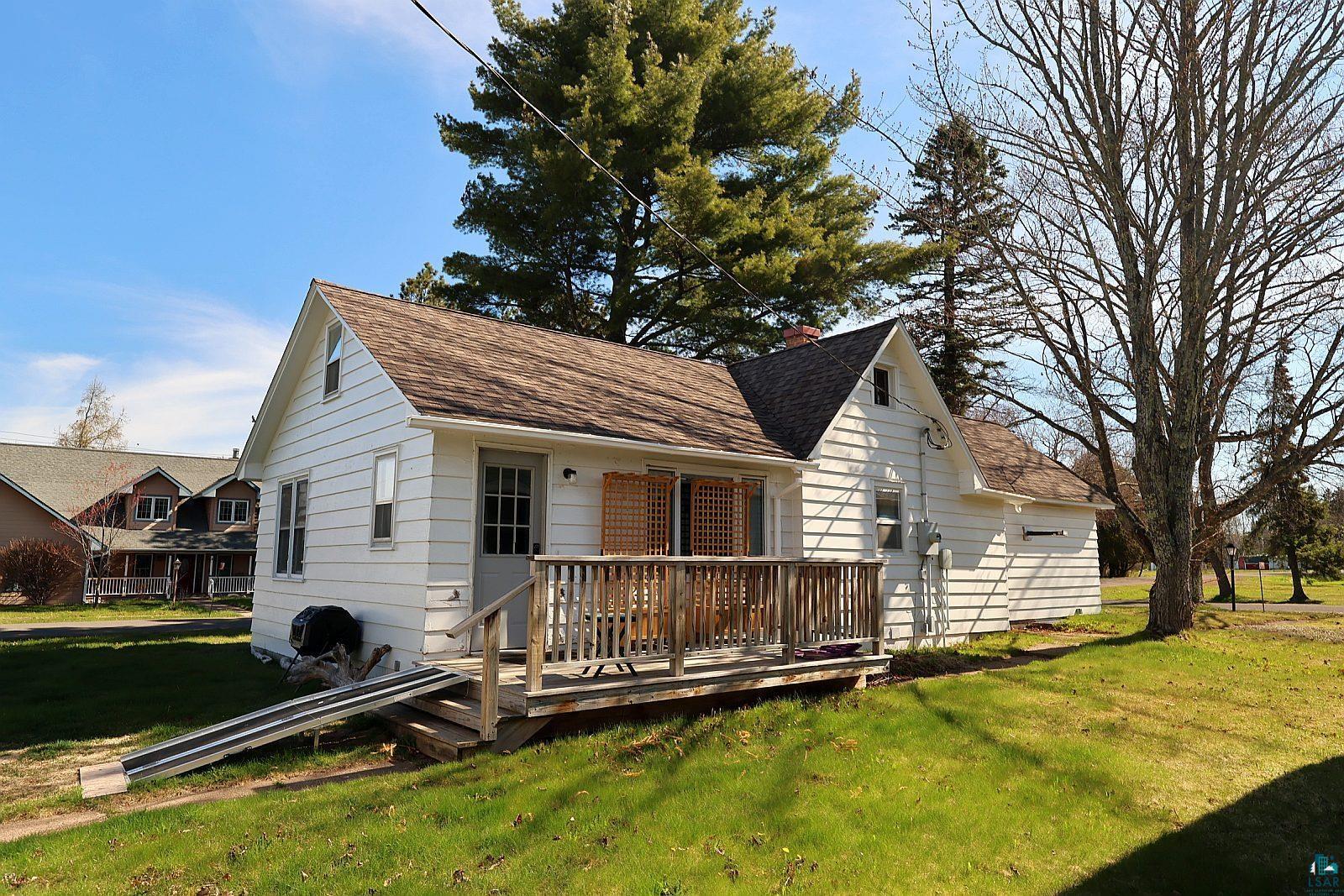 83185 Washington Avenue Port Wing, WI 54865 - Photo 25 of 26 White-sided residence featuring a gabled roofline and an inviting front porch