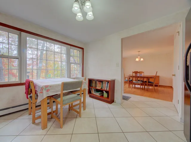 a dining room with furniture and a chandelier