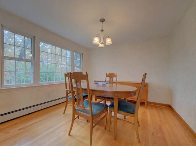 a view of a dining room with furniture window and wooden floor