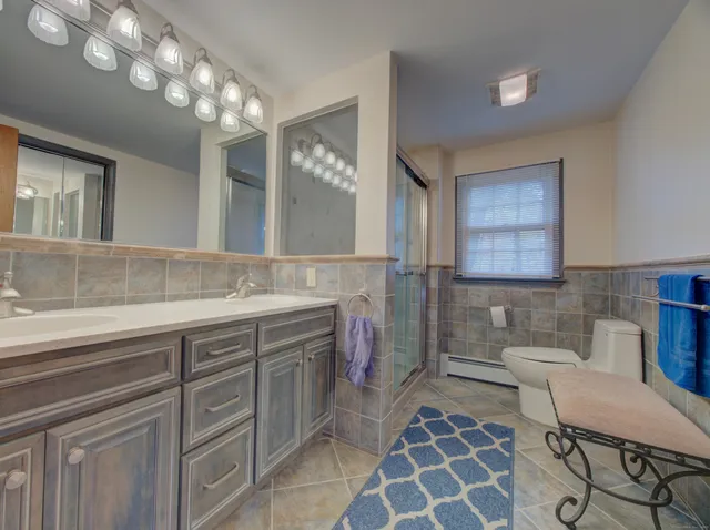 a spacious bathroom with a double vanity sink mirror and