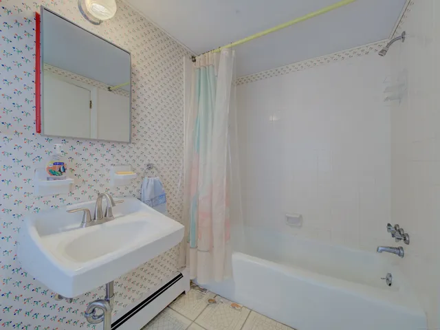 a bathroom with a sink a mirror and a bathtub