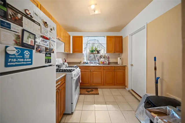 a kitchen with a sink a stove cabinets and a window