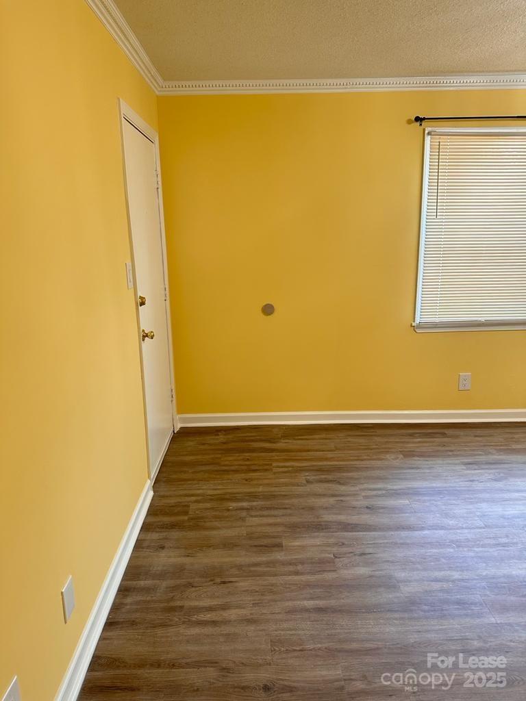 5808 Hunting Ridge Lane, Unit A Charlotte, NC 28212 - Photo 13 of 18 a view of an empty room with wooden floor and a window